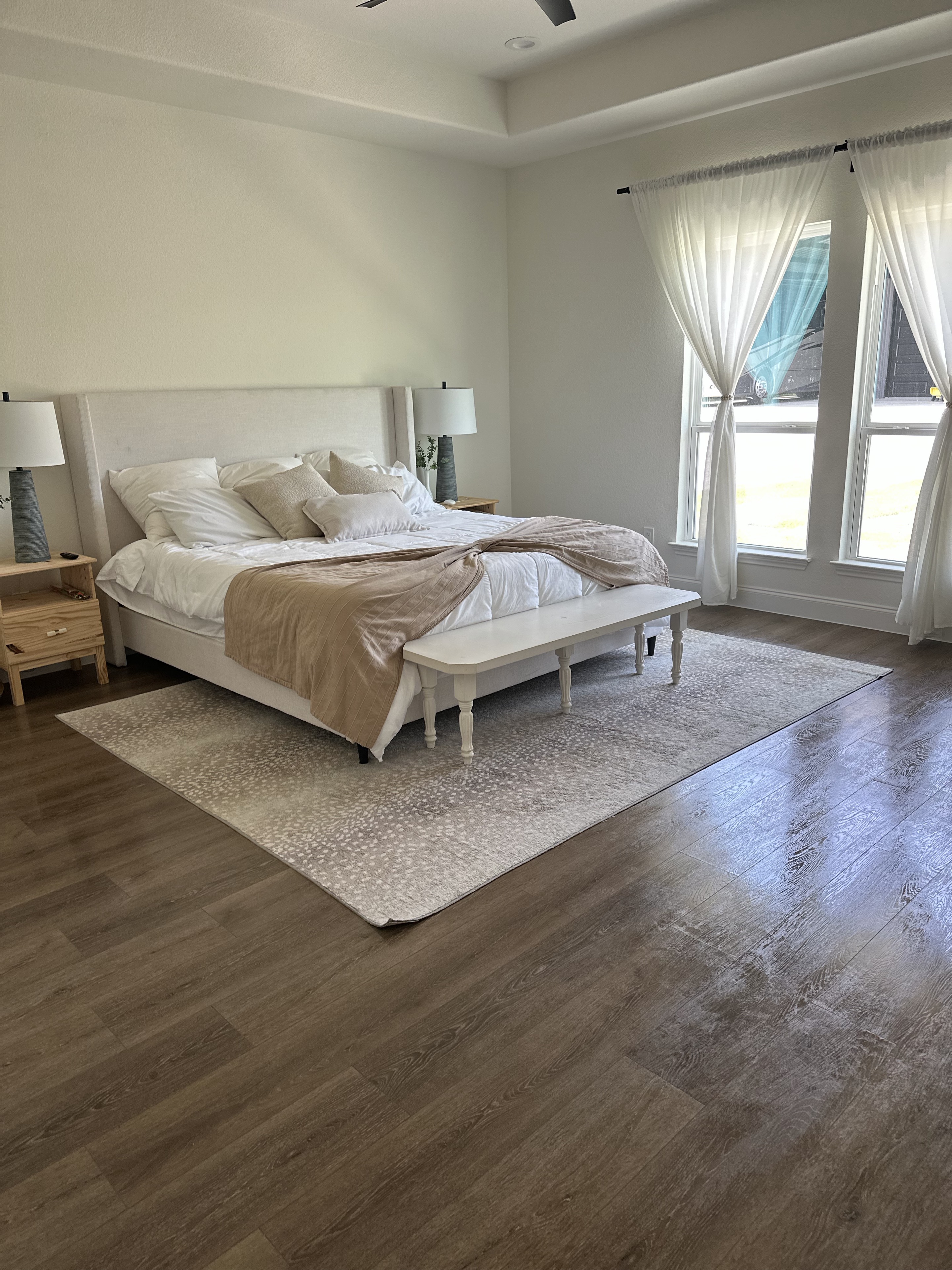 Guest bedroom with white bedding and a blush throw